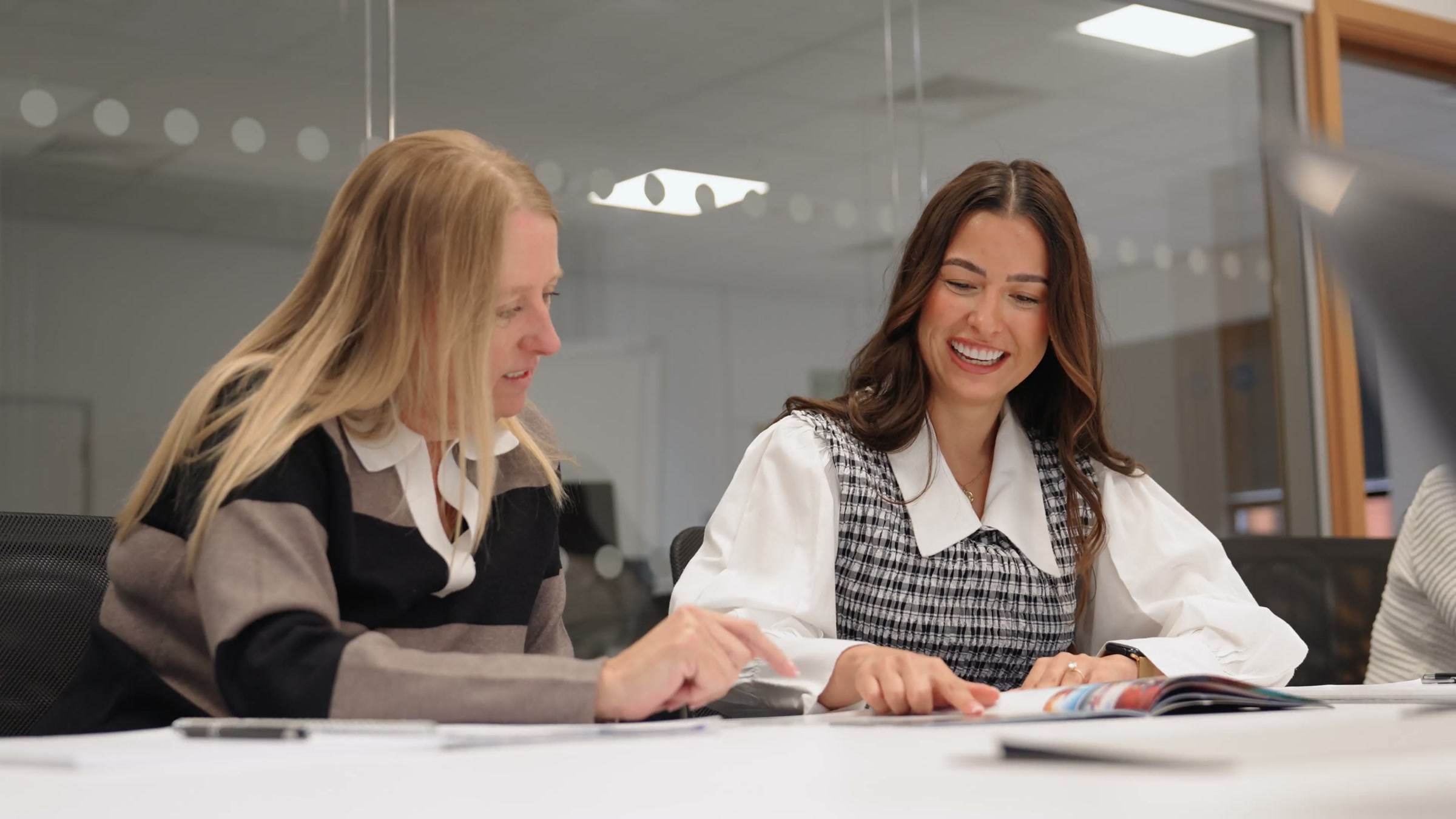 Two colleagues reviewing creative work together